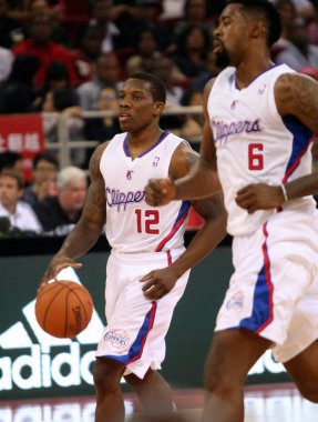 Eric Bledsoe of the Los Angeles Clippers, left, dribbles against the Miami Heat during a basketball match of their NBA China Games in Beijing, China, 11 October 2012 clipart