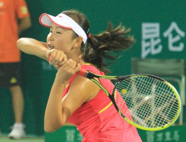 Chinese tennis player Peng Shuai finishes a forehand strike in a two straight set win against Thailand counterpart Nudnida Luangnam in the 2nd round of 2012 WTA Guangzhou in Guanzhou, south Chinas Guangdong province, 19 September 2012. clipart