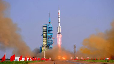 A Long March 2F (CZ-2F) carrier rocket carrying the Shenzhou-9 (Shenzhou IX) spacecraft with three Chinese astronaut (two male, one female) blasts off at the Jiuquan Satellite Launch Center near Jiuquan city, northwest Chinas Gansu province, 16 June  clipart