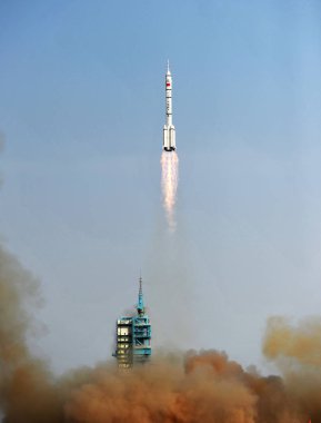 A Long March 2F (CZ-2F) carrier rocket carrying the Shenzhou-9 (Shenzhou IX) spacecraft with three Chinese astronaut (two male, one female) blasts off at the Jiuquan Satellite Launch Center near Jiuquan city, northwest Chinas Gansu province, 16 June  clipart