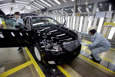 Chinese workers check Toyota Crown cars on the assembly line at an auto plant of Toyota in Tianjin, China, 23 March 2012 clipart