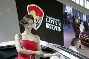 A model poses with a Lotus car of Zhejiang Youngman Automobile Group during the 12th Beijing International Automotive Exhibition, known as Auto China 2012, in Beijing, China, 28 April 2012 clipart