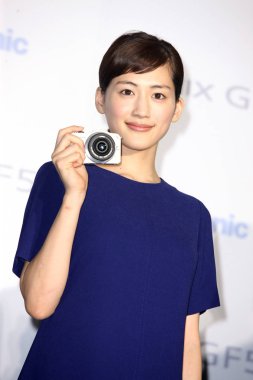 Japanese actress Haruka Ayase poses with a camera during the Panasonics promotional activity in Taipei, Taiwan, 10 June 2012. clipart