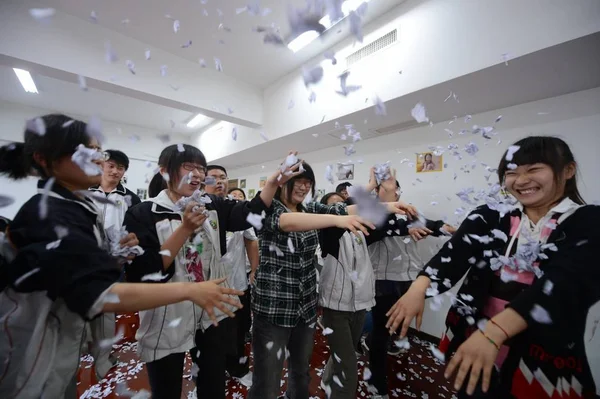 中国人留学生は 2012 日東中国江蘇省揚州市の高校で年間国立大学入試前に活動中のストレスを発散する紙吹雪をまく — ストック写真