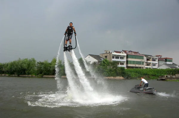 フロンは 東中国浙江省ヘイニング市の運河に Jetlev フライヤーを使用して 飛行性能を作ります 月2012 — ストック写真