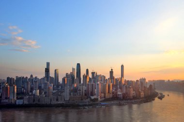 --File--Skyline of Yuzhong Peninsula with skyscrapers and high-rise buildings at the juction of the Yangtze River and the Jialing River at sunrise in Chongqing, China, 28 July 201 clipart