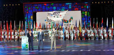 A representative of Kazan flourishes the FISU flag at the closing ceremony of 26th Summer Universiade in Shenzhen, south Chinas Guangdong province, China, 23 August 2011 clipart