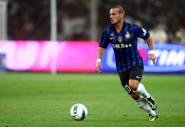 Wesley Sneijder of Inter Milan dribbles during the Italian Super Cup 2011 match against AC Milan at the National Stadium, known as the Birds Nest, in Beijing, China, 6 August 2011 clipart
