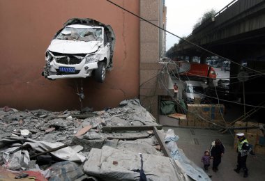 A car protrudes from a wall after it crashed half way through the wall at a garage in Chongqing, China, March 1, 2011 clipart