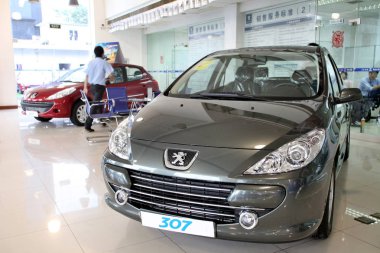 Peugeot cars are displayed at a Peugeot dealership in Shanghai, China, 15 September 2010 clipart