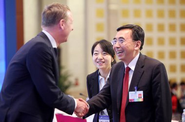 Zhu Xiaodan, right, acting governor of Guangdong Province, shakes hands with Hans Vestberg, President and CEO of Ericsson, at a press conference for the International Consultative Conference on the Future Economic Development of Guangdong Province in clipart