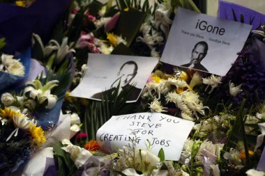 Flowers and cards are dedicated outside the Apple Store on Nanjing East Road to mourn for Steve Jobs in Shanghai, China, 7 October 2011 clipart