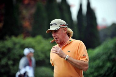 Miguel A Jimenez of Spain smokes in the final round of the 2011 WGC-HSBC Champions golf tournament at the Sheshan International Golf Club in Shanghai, China, 6 November 2011 clipart