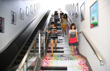 Pedestrians walk on the piano stairs that can produce melodious sounds at a subway station in Nanjing, east Chinas Jiangsu province, 1 September 2011. clipart