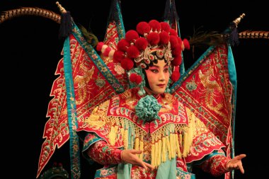 A player dressed in the costume of sheng, one of the 4 main characters in Beijing Opera, performs in a theater in Haikou, south Chinas Hainan province, 17 January 2011 clipart