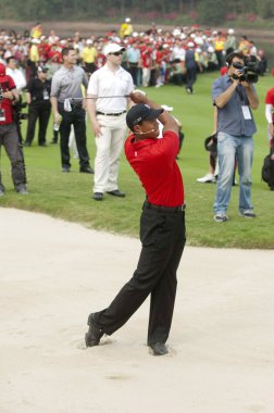 U.S. golf superstar Tiger Woods conducts a golf clinic for junior Chinese golfers at the Mission Hills Golf Club in Dongguan city, south Chinas Guangdong province, 12 April 2011 clipart