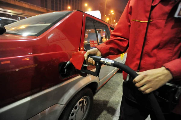 2011年10月8日 在中国东北辽宁省沈阳市的一个加油站 一名工人为一辆汽车加油 — 图库照片