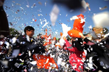 Young Chinese students enjoy a pillow fight to celebrate the forthcoming centenary Singles Day which falls on 2011/11/11 at Yangzhou University in Yangzhou city, east Chinas Jiangsu province, 10 November 2011 clipart
