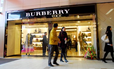 Pedestrians walk past a Burberry store in Nanning, south Chinas Guangxi province, 29 January 2011 clipart
