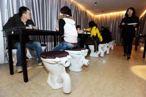화장실에 앉아있는 중국인 고객은 화장실을 테마로 레스토랑에서 먹는다 후베이 2010 — 스톡 사진