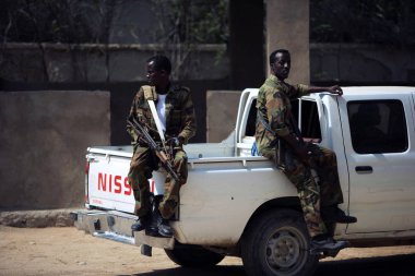 Somali soldiers sit on a pick-up to patrol at the goverment of Bari administrative region in Bosaso, Somalia, 20 January 2009 clipart