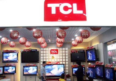 Visitors look at LCD televisions at the stand of TCL during an exhibition in Shanghai, China, April 6, 2008 clipart