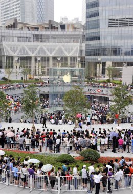 A large crowd of customers queue up in circles around the Apple Store at the Lujiazui Financial District in Pudong, Shanghai, China, July 10, 2010 clipart