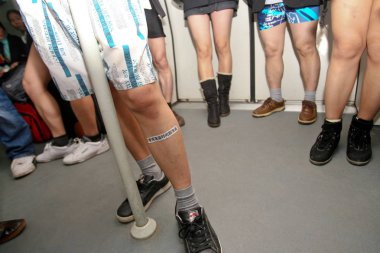 Young Chinese climate activists who stripped down to their pants and boxers are seen in a metro train during a campaign to promote environmental protection and low-carbon lifesyle in Guangzhou city, south Chinas Guangdong province, 17 January 2010 clipart