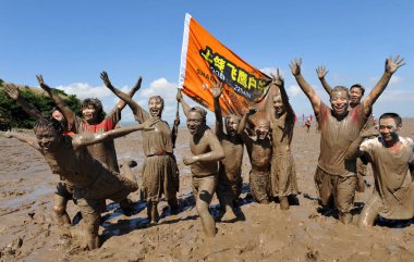 Tourists have fun in mud during a mud carnival at the sea mud park on Xiushan Island of Daishan county, Zhoushan city, east Chinas Zhejiang Province, 19 July 2010 clipart