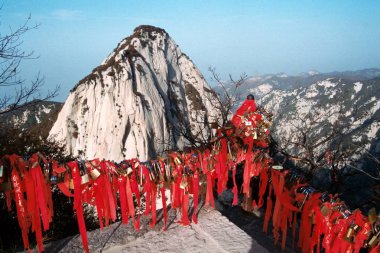 Locks of love, peace and other wishes with red ribbons are hung on the iron chains on the Lotus Peak of the Huashan Mountain (Mount Hua or Hua Mountain) in northwest Chinas Shaanxi province, 7 November 2005. clipart