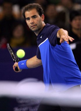Pete Sampras of America returns a shot during 2011 Li Na & Friends International Tennis Classic in Wuhan, central Chinas Hubei province, 18 December 2011. clipart