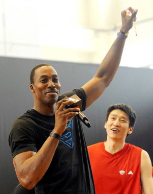 NBA player Dwight Howard of the Orlando Magic, right, poses next to Chinese basketball player Sun Yue, front left, and young Chinese basketball lovers during the opening ceremony of the Shenyang competition area of the Adidas Basketball Summer League clipart