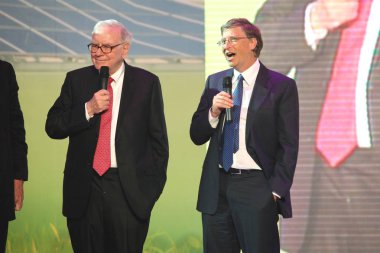Bill Gates (right), U.S. business magnate, philanthropist and Chairman of Microsoft and U.S. investor and philanthropist Warren Buffet are seen at the nationwide launching ceremony of Chinese electric vehicle BYD M6 and a clean energy project in Tibe clipart