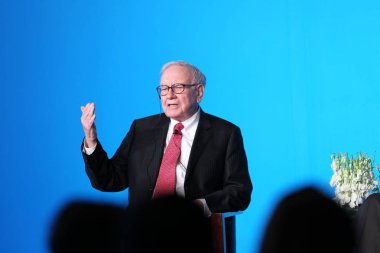 U.S. investor and philanthropist Warren Buffet answers a question during a press conference in Beijing, China, 30 September 2010 clipart