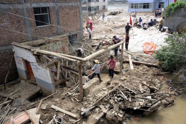 Local residents search for survivors and victims on the debris of the mudslide devastation in Zhouqu county, Gannan Tibetan Autonomous Prefecture, northeast Chinas Gansu province, August 11, 2010 clipart
