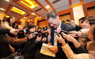 Su Ning, center, Deputy Governor of the Peoples Bank of China (PBOC) and a delegate of CPPCC (Chinese Peoples Political Consultative Conference), the countrys top political advisory body, is surrounded by reporters after a group discussion in Beijing clipart