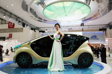 A model poses next to the IAT Zhu Feng (Bamboo Wind) EV Concept at the 11th Beijing International Automotive Exhibition, known as Auto China 2010, in Beijing, China, 23 April 2010. clipart