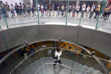 Customers queue up outside the Apple store in the Lujiazui Financial District to buy the iPad in Pudong, Shanghai, China, 17 September 2010 clipart