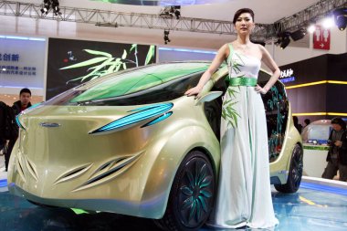 A model poses next to the IAT Zhu Feng (Bamboo Wind) EV Concept at the 11th Beijing International Automotive Exhibition, known as Auto China 2010, in Beijing, China, 23 April 2010. clipart