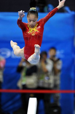 Chinas Sui Lu performs on the balance beam during the Womens Qualification and Team Final in the Artistic Gymnastics at the 16th Asian Games in Guangzhou city, south Chinas Guangdong province, 14 November 2010. clipart