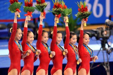 (From left) Chinas Yang Yilin, Huang Qiushuang, Sui Lu, He Kexin, Jiang Yuyuan and Deng Linlin celebrate their gold medals on the podium during the award ceremony of the Womens Qualification and Team Final in the Artistic Gymnastics at the 16th Asian clipart