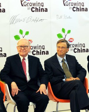 U.S. investor and philanthropist Warren Buffet, left, and Microsoft co-founder Bill Gates are seen during the opening ceremony of a Dairy Queen ice cream shop at the Joy City shopping mall in Beijing, China, 30 September 2010. clipart