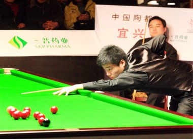 Chinese snooker star Ding Junhui aims while competing against Chinese snooker player Tang Jun at the final of the China Professional Snooker Tournament 2008 in Yixing city, east Chinas Jiangsu province, Wednesday, 31 December 2008 clipart