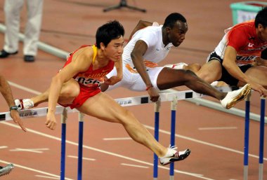 Chinas star hurdler Liu Xiang, left, competes in the mens 110m hurdles round 1 heats at the 16th Asian Games in Guangzhou city, south Chinas Guangdong province, 22 November 2010 clipart