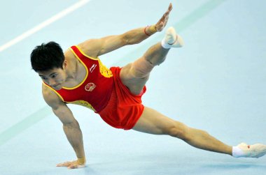 Chinas Teng Haibin competes on the floor in the mens individual all-around final at the 16th Asian Games in Guangzhou city, south Chinas Guangdong province, 15 November 2010. clipart