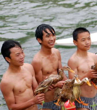 Contestants hold ducks during the duck scramble event to celebrate the Dragon Boat Festival, in Majiang county, southwest Chinas Guizhou province, Saturday, May 30, 2009 clipart