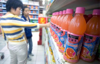 Bottles of Minute Maid, a kind of juice manufactured by Coca-Cola are seen for sale at a supermarket in Shanghai, China, May 20, 2009 clipart