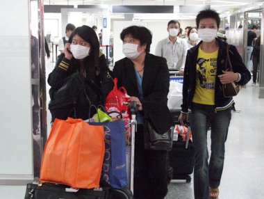 Passengers from Japan wearing masks against the A(H1N1) flu arrive at the Shanghai Hongqiao International Airport in Shanghai, China, Wednesday, 20 May 2009 clipart