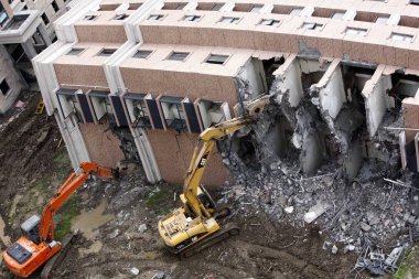 Excavators are seen dismantling the toppled apartment building at the construction site of the Lotus Riverside apartment complex in Minhang District, Shanghai, China, Wednesday, 5 August 2009 clipart