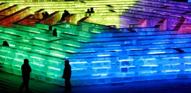Tourists enjoy the time inside the illuminated ice sculpture palaces at the 8th Harbin Ice and Snow World Festival held in Harbin city, capital of northeast Chinas Heilongjiang province, December 30, 2006.  clipart